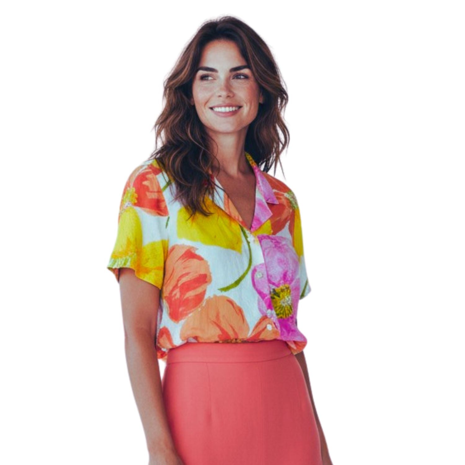 A woman wearing a short-sleeve collared blouse with a bright multicolor floral print in yellow, pink, orange, and green on a white base, paired with a coral pink skirt, against a plain white background.