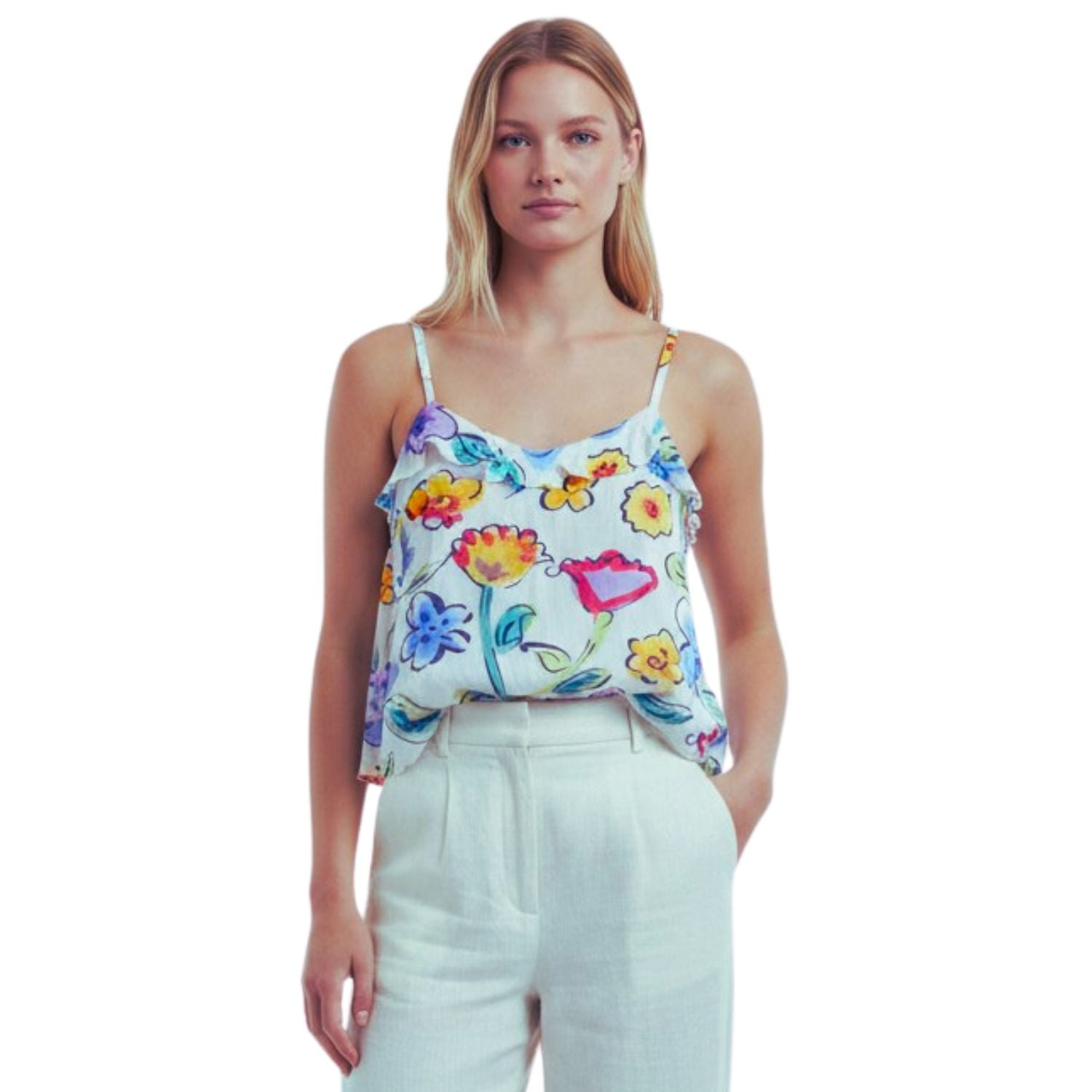 A woman modeling a white spaghetti-strap camisole top with a colorful floral and butterfly print, paired with white trousers, against a plain white background.