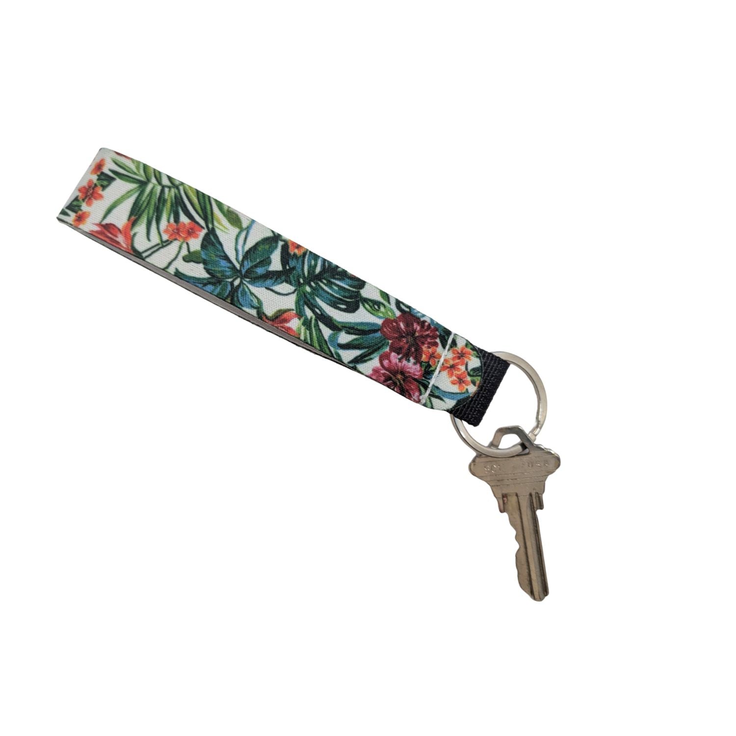A fabric keychain with a tropical floral print on a white background, featuring a silver metal keyring and a single key.