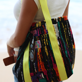 Colorful bag with a pattern held by a person, with a blurred background