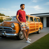 Man leaning against a vintage orange car with a wooden panel design on a sunny day.
