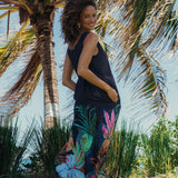 Woman in a colorful dress standing among palm trees