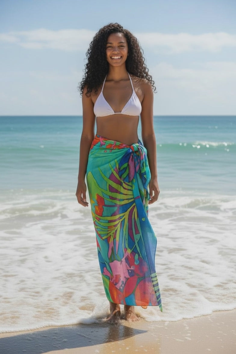 Model wearing Volare Print Pareo on beach.