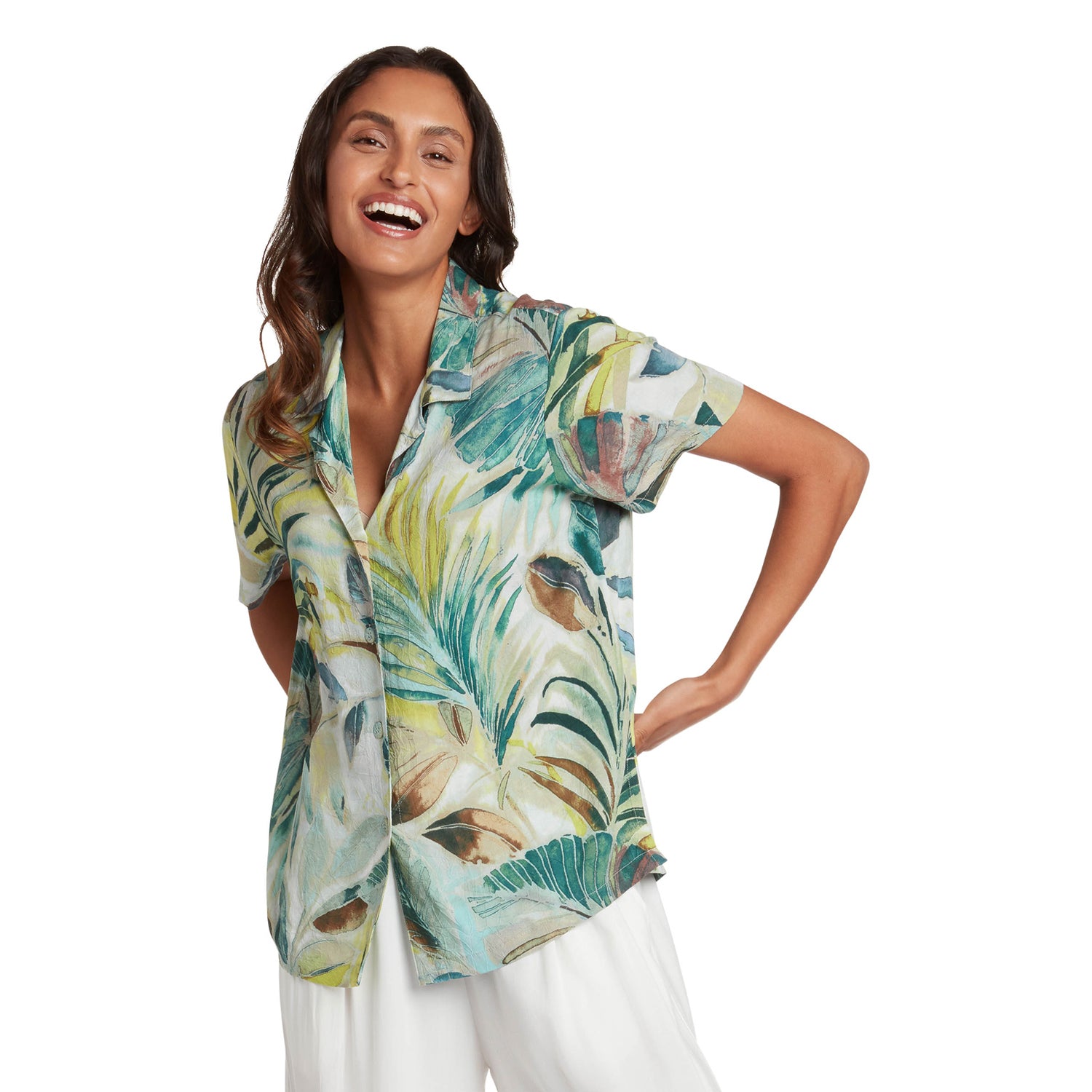 Woman wearing a tropical leaf patterned shirt on a white background